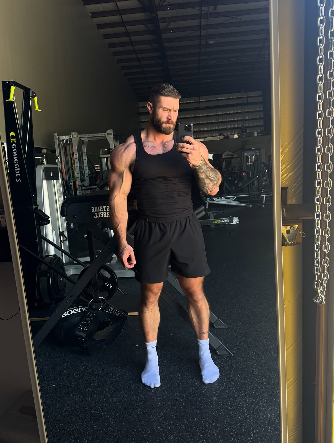 Photo shared by Chris Bumstead on November 28, 2025 tagging @gymshark, and @rawnutrition. May be an image of one or more people, beard, biceps and text.