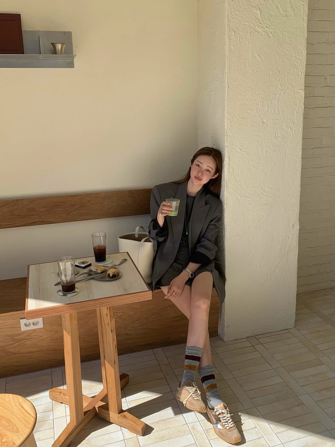 Photo shared by 차정원 on September 15, 2025 tagging @goldengoose. May be an image of 1 person, deck chair, cornflower and text.