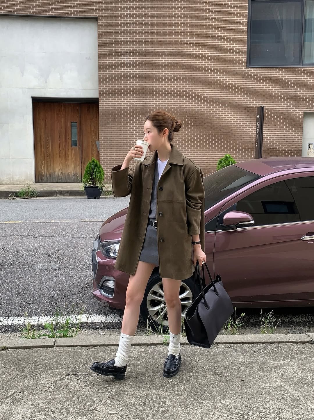 Photo shared by 차정원 on September 12, 2025 tagging @joygryson_official. May be an image of 1 person, wingtip shoes, duffle coat, overcoat, cigarette, suit, miniskirt, blazer and text.