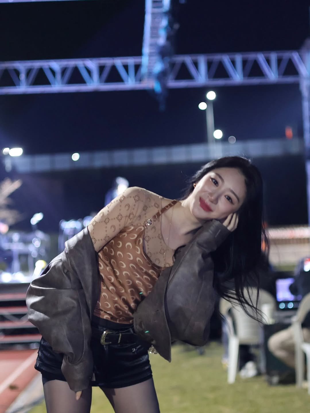 Photo by 이채연 Leechaeyeon on October 29, 2025. May be an image of one or more people, hair, top, miniskirt, outdoors and text.