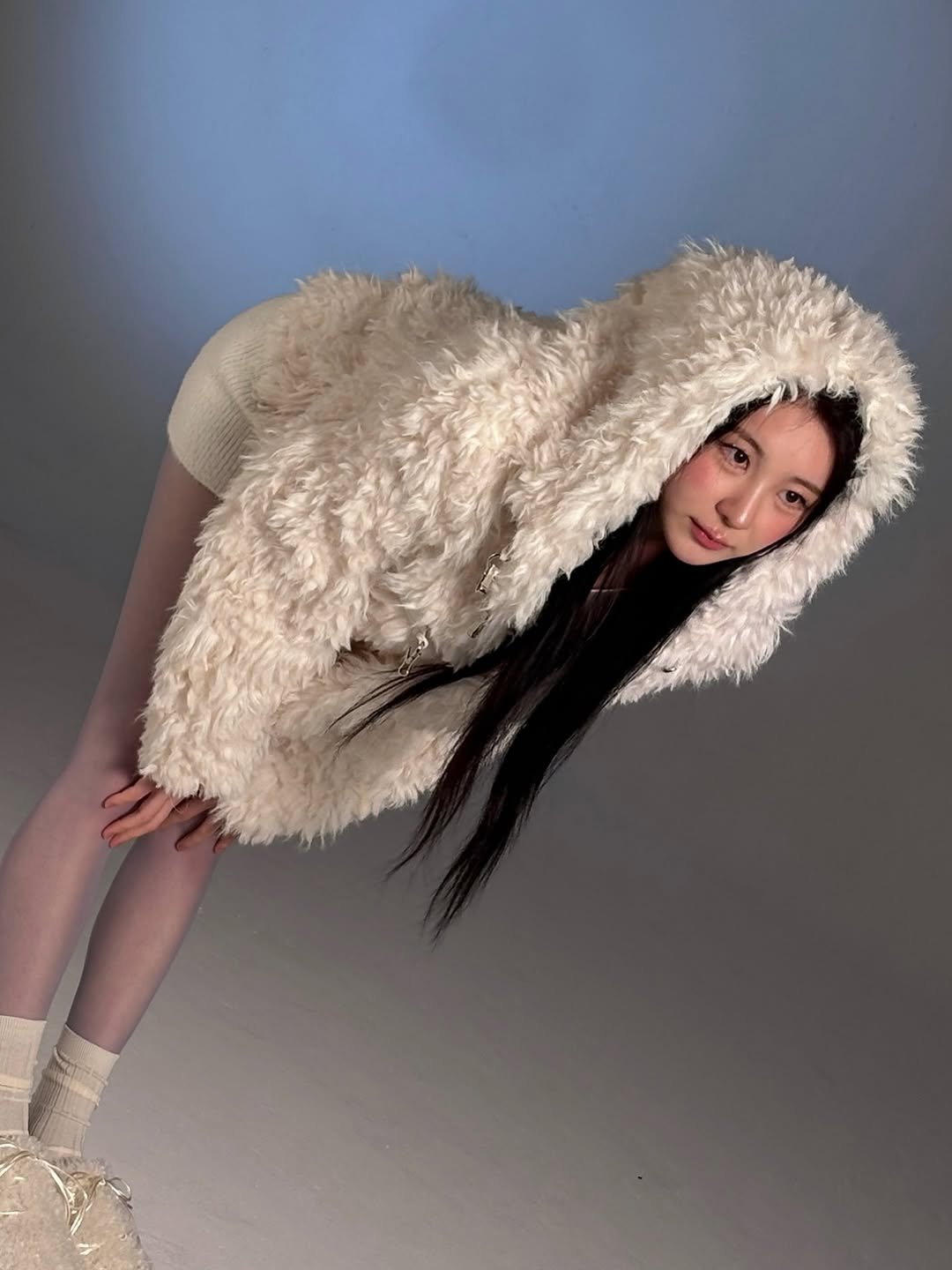 Photo by 이채연 Leechaeyeon on January 25, 2026. May be an image of one or more people, braids, makeup, fur coat, goosedown coat, headdress, parka, cloak and text.
