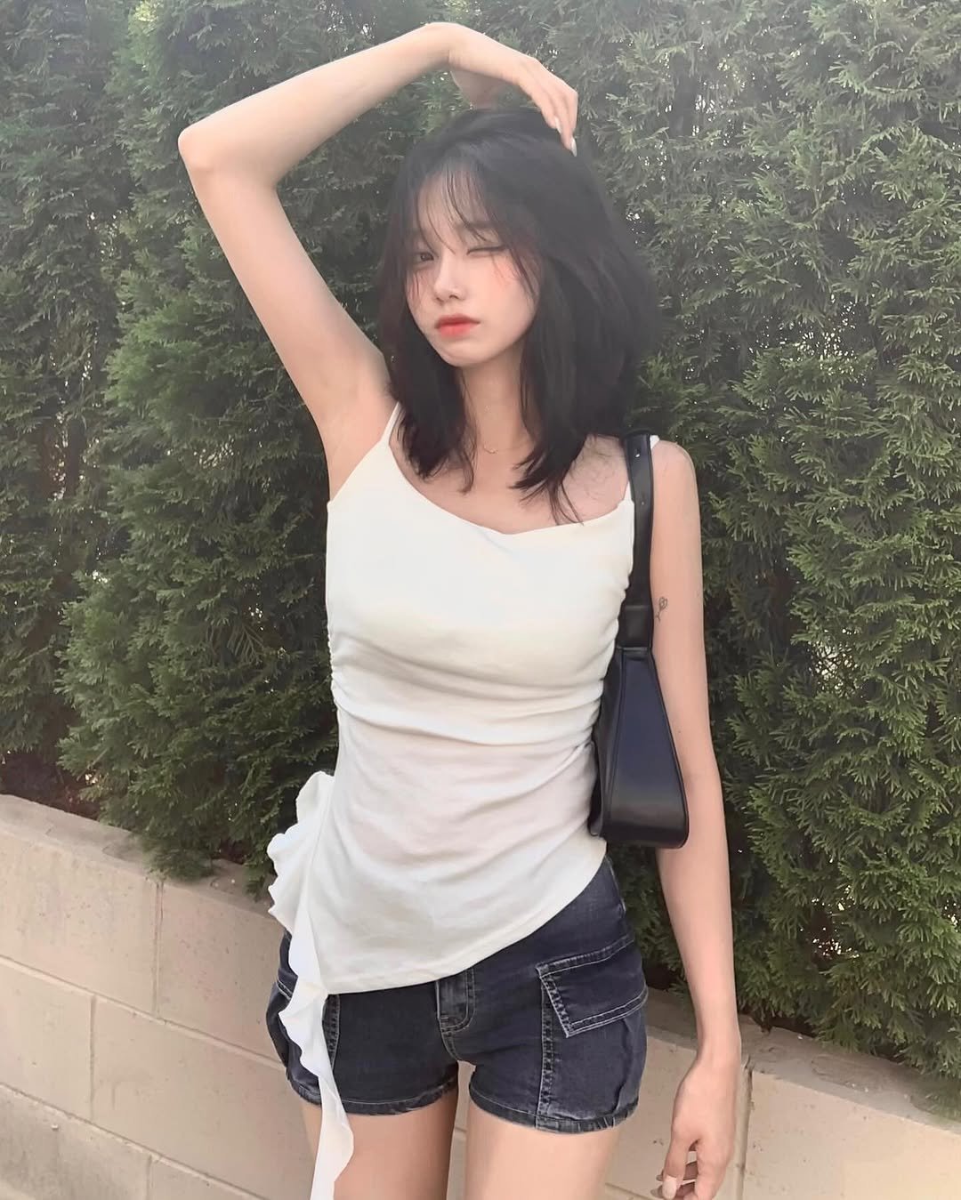 Photo by 차진아 on July 09, 2025. May be an image of 1 person, hair, shorts, top, tanktop and text.