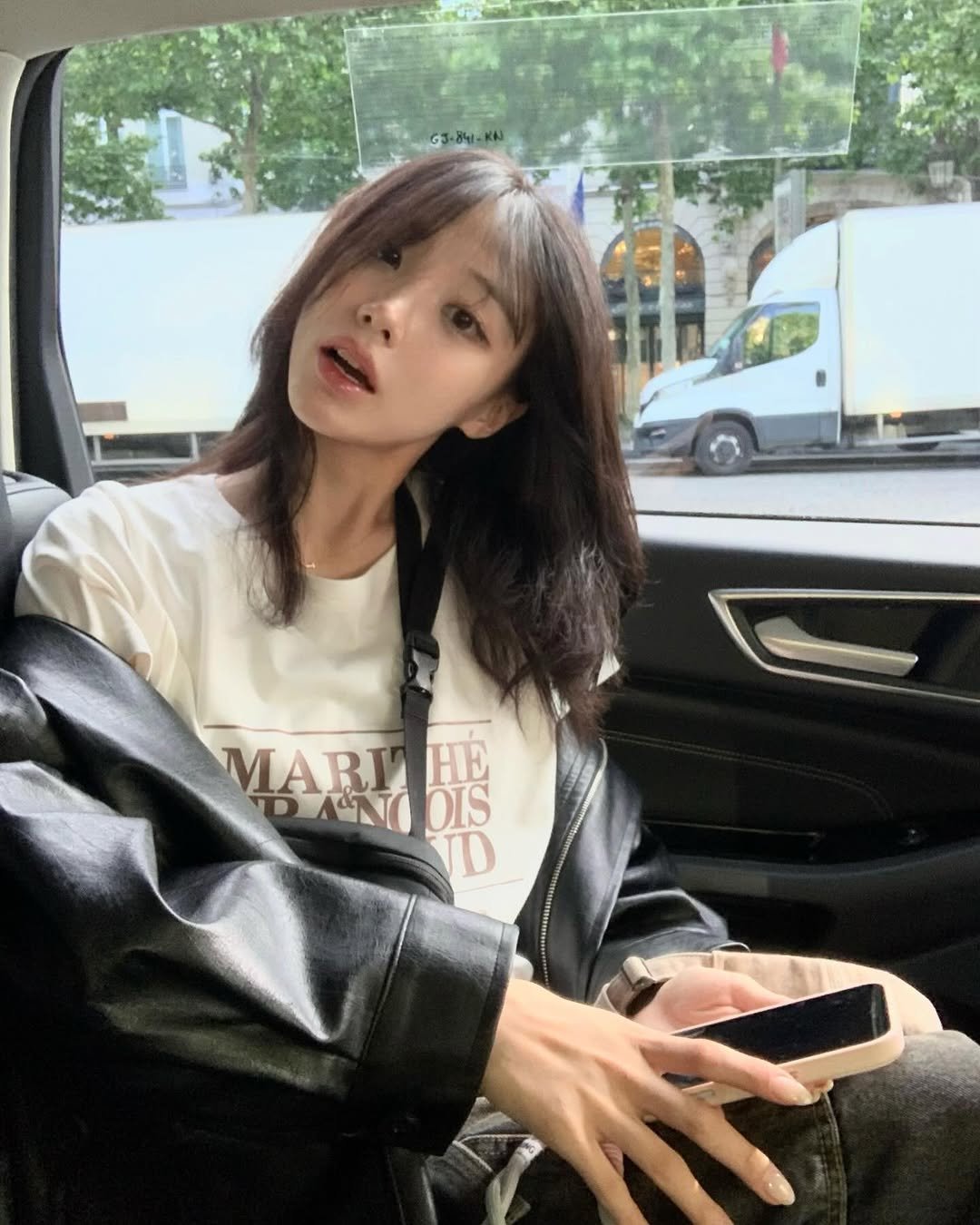 Photo by 차진아 on May 15, 2025. May be an image of 1 person, hair, top, bus, parka and text.