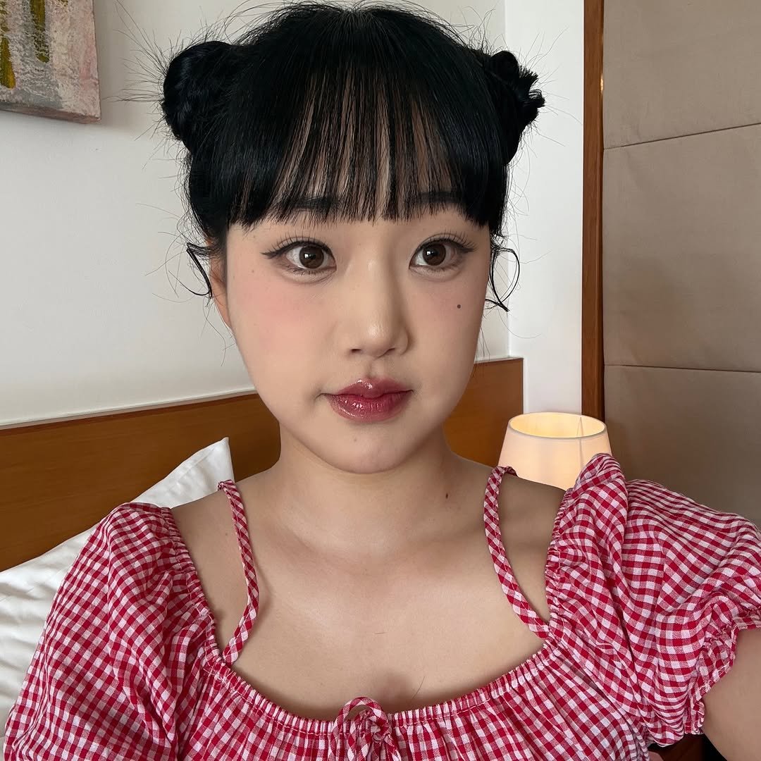 Photo by 지하니🍒💛 on August 23, 2025. May be an image of 1 person, braids, makeup, sleepwear, top and text.