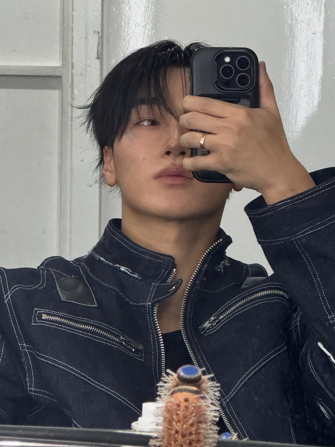 Photo by 산 (SAN) on February 06, 2026. May be an image of one or more people, bangs, bolo tie, mirror and text.