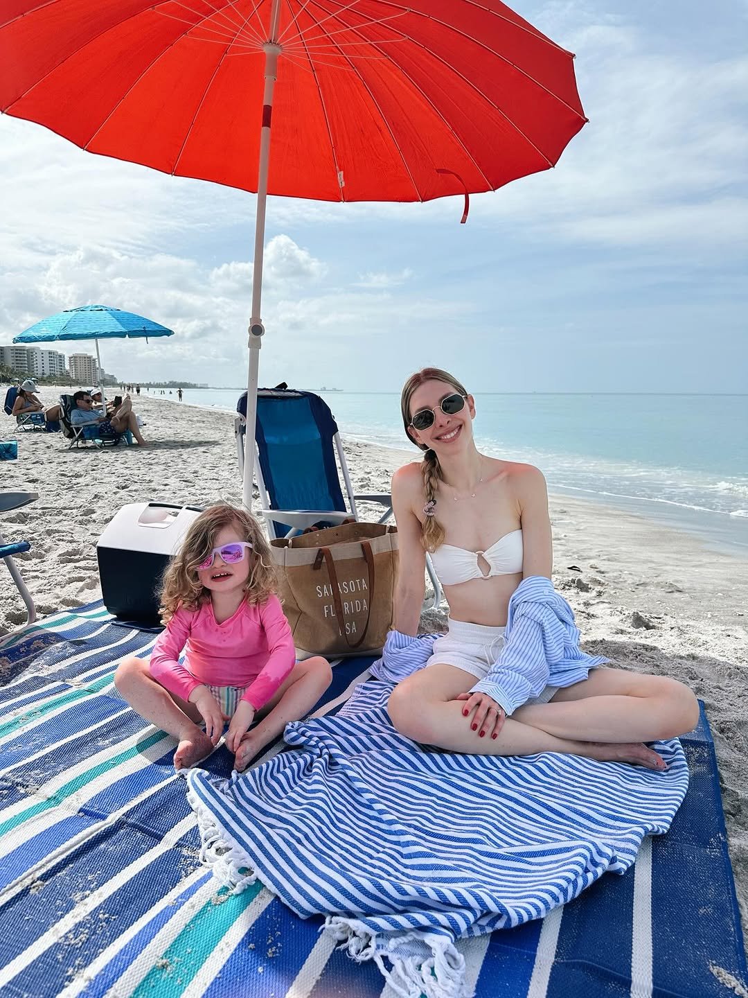 Photo by Jess Hoffman on April 13, 2026. May be an image of towel, parasol, umbrella, beach and text.