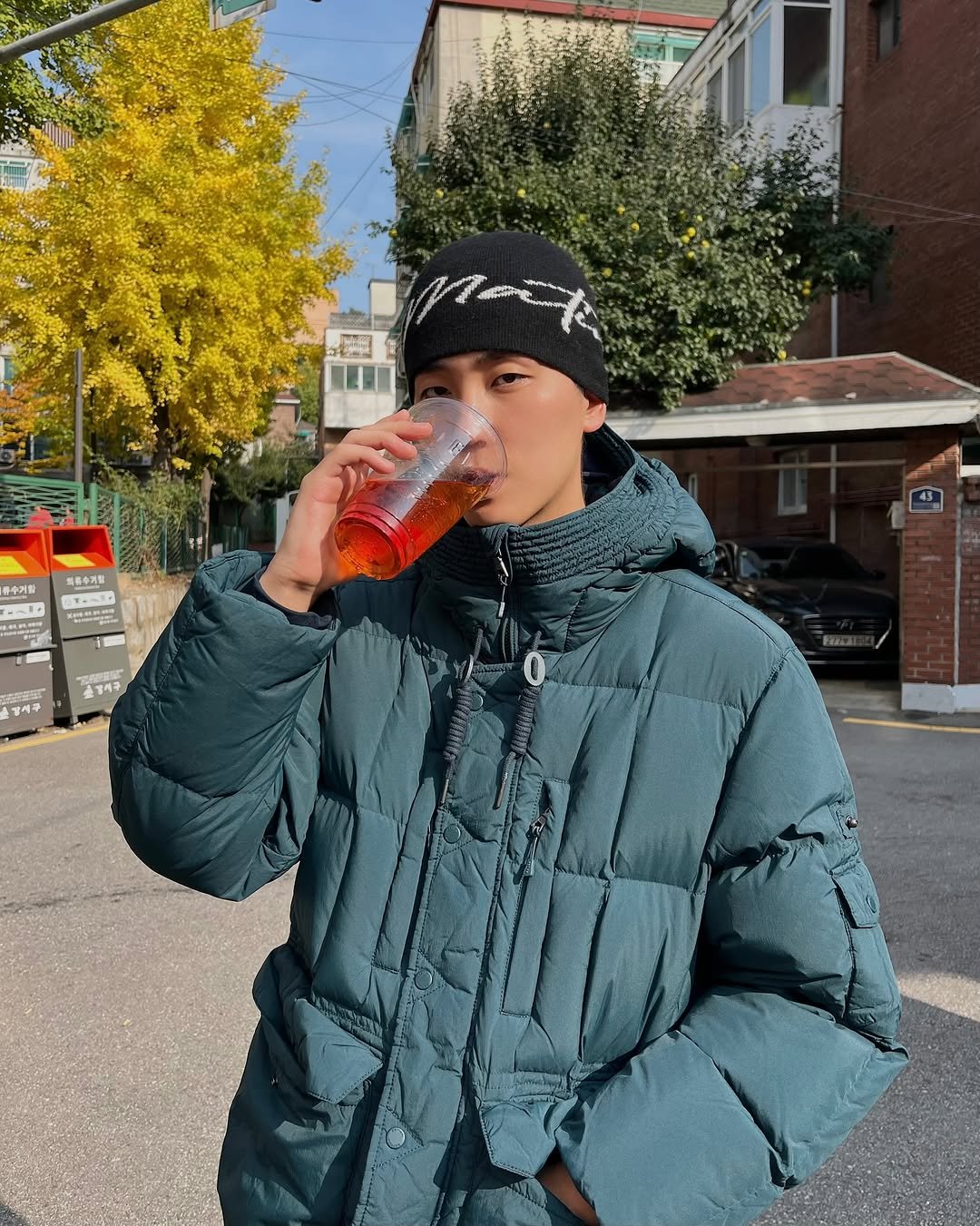 Photo shared by 김정철 on November 02, 2025 tagging @byseries_official. May be an image of duffle coat, goosedown coat, drink, parka, fleece, beret, cornflower and text.