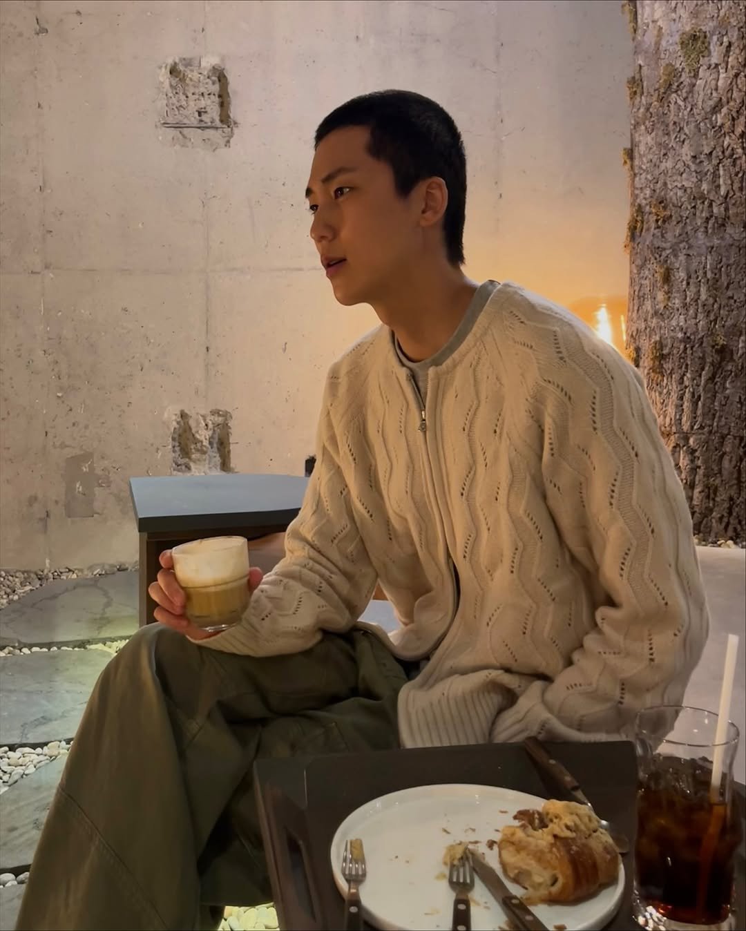 Photo shared by 김정철 on November 07, 2025 tagging @mmic_official. May be an image of top, sweater, turtleneck and text.