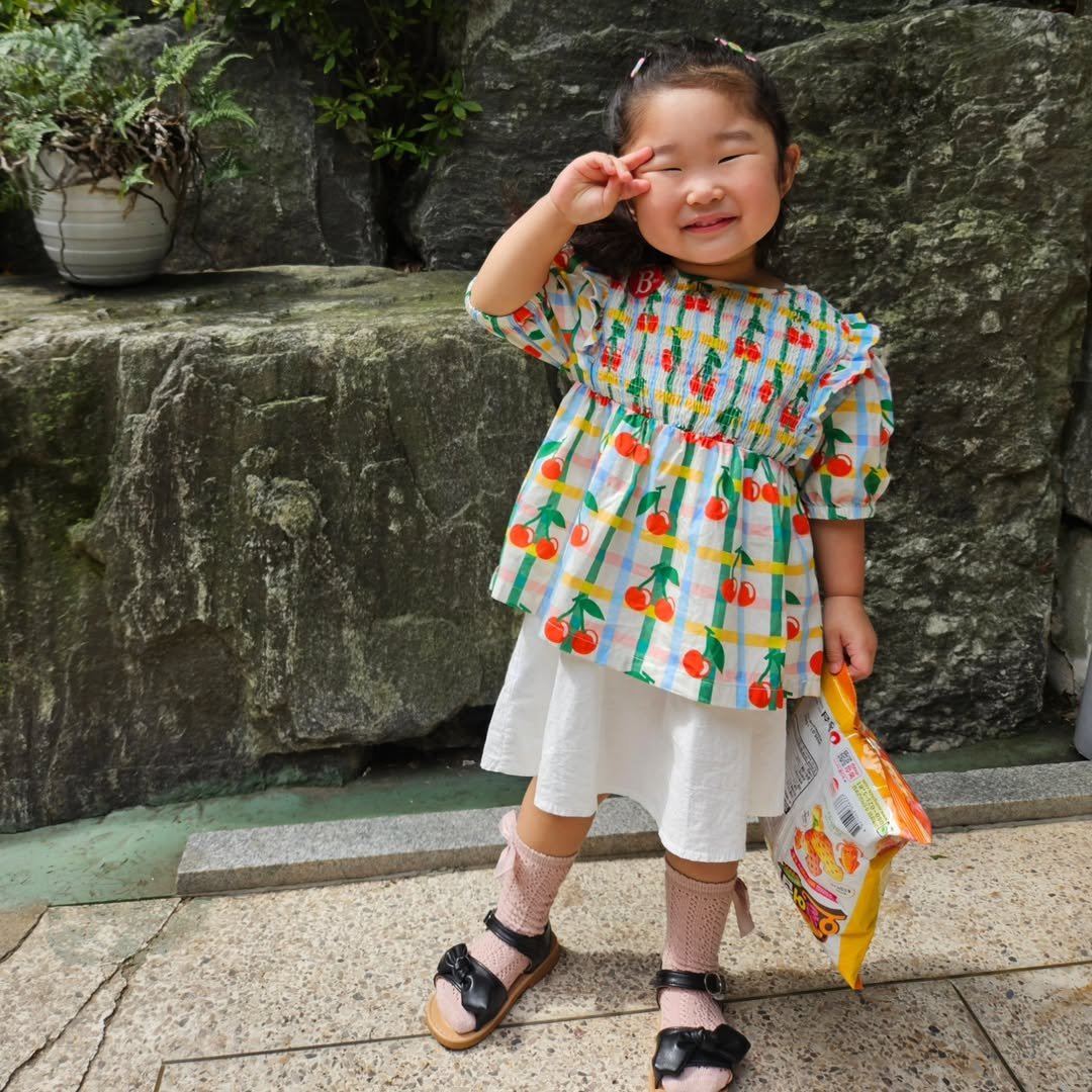 Photo by 혜진 on July 24, 2025. May be an image of 1 person, baby, baby shoes, dress, sundress and text.