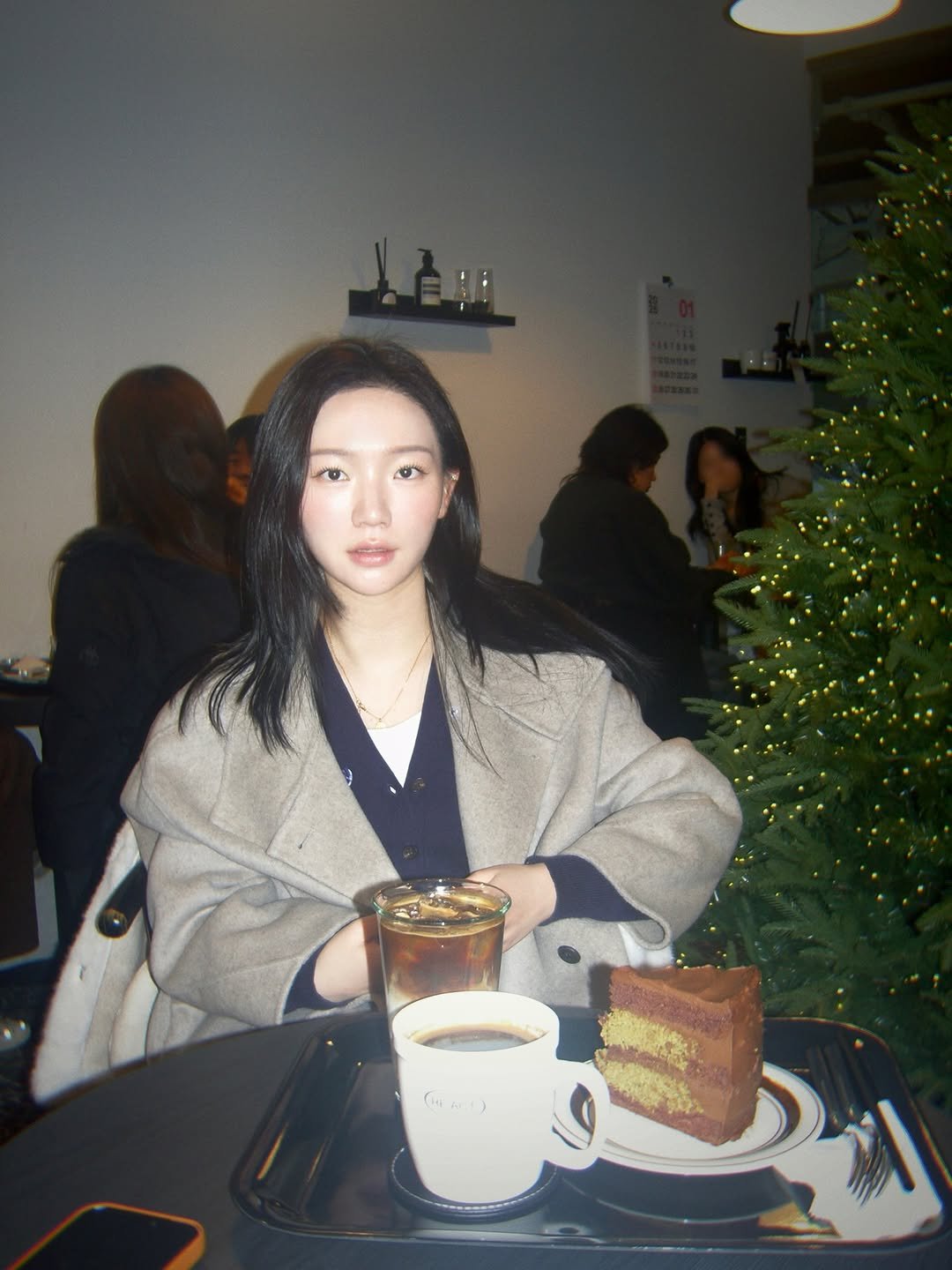 Photo by 예린 on January 31, 2026. May be an image of one or more people, hair, duffle coat, turtleneck, cornflower and text.