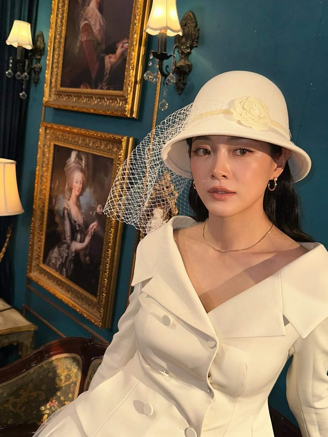 Photo by 김세정 on December 23, 2025. May be an image of hat, coat, dress, bowler hat and text.