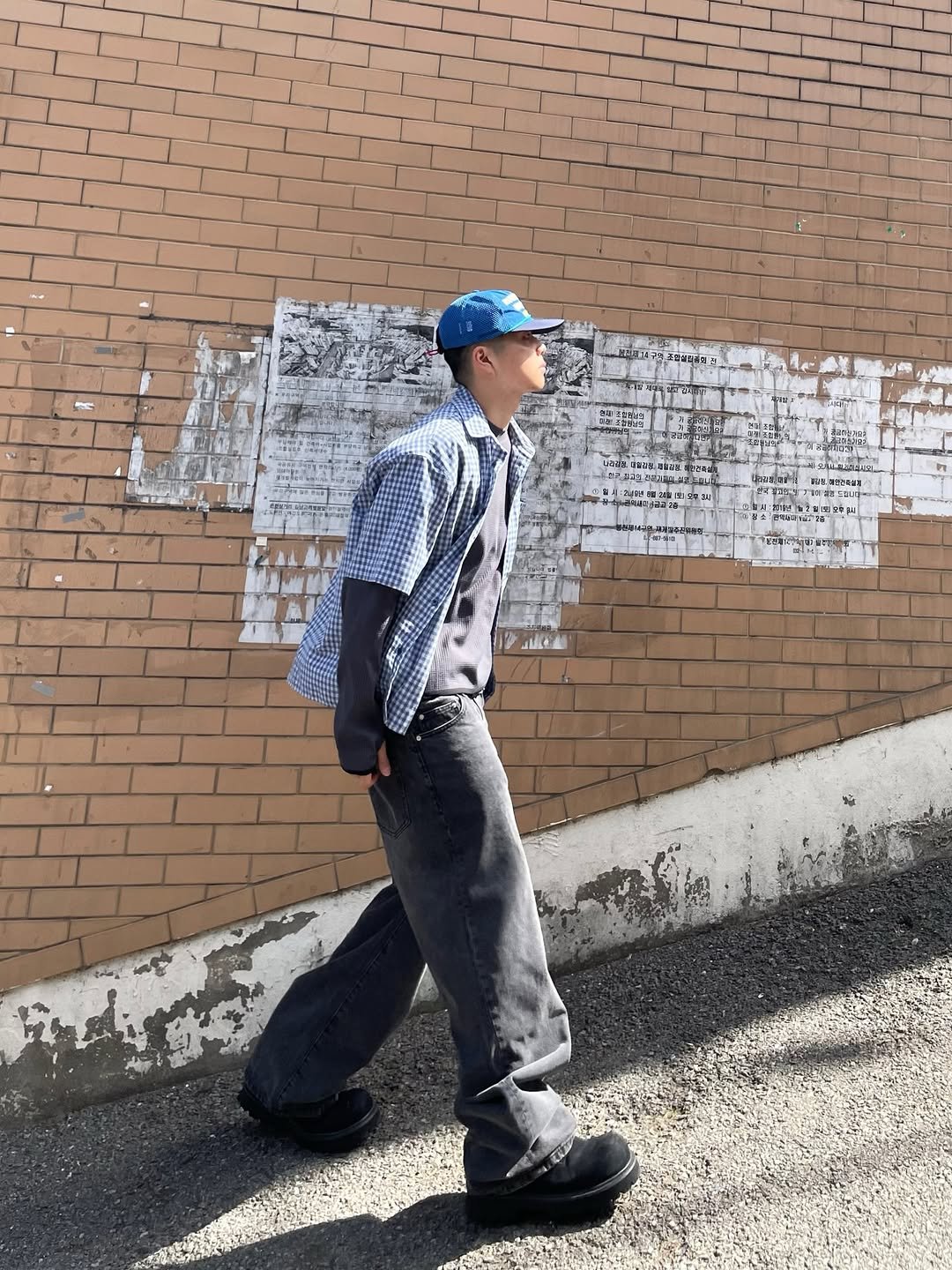 Photo shared by 정인 on April 27, 2026 tagging @psshopper_company. May be an image of standing, cornflower, street, brick wall and text.