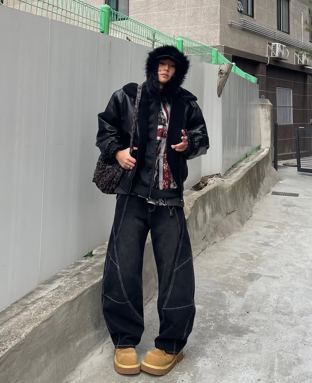 Photo shared by 정인 on January 29, 2026 tagging @otherfits_. May be an image of overcoat, goosedown coat, duffle coat, face mask, jacket, raincoat, parka, street and text.