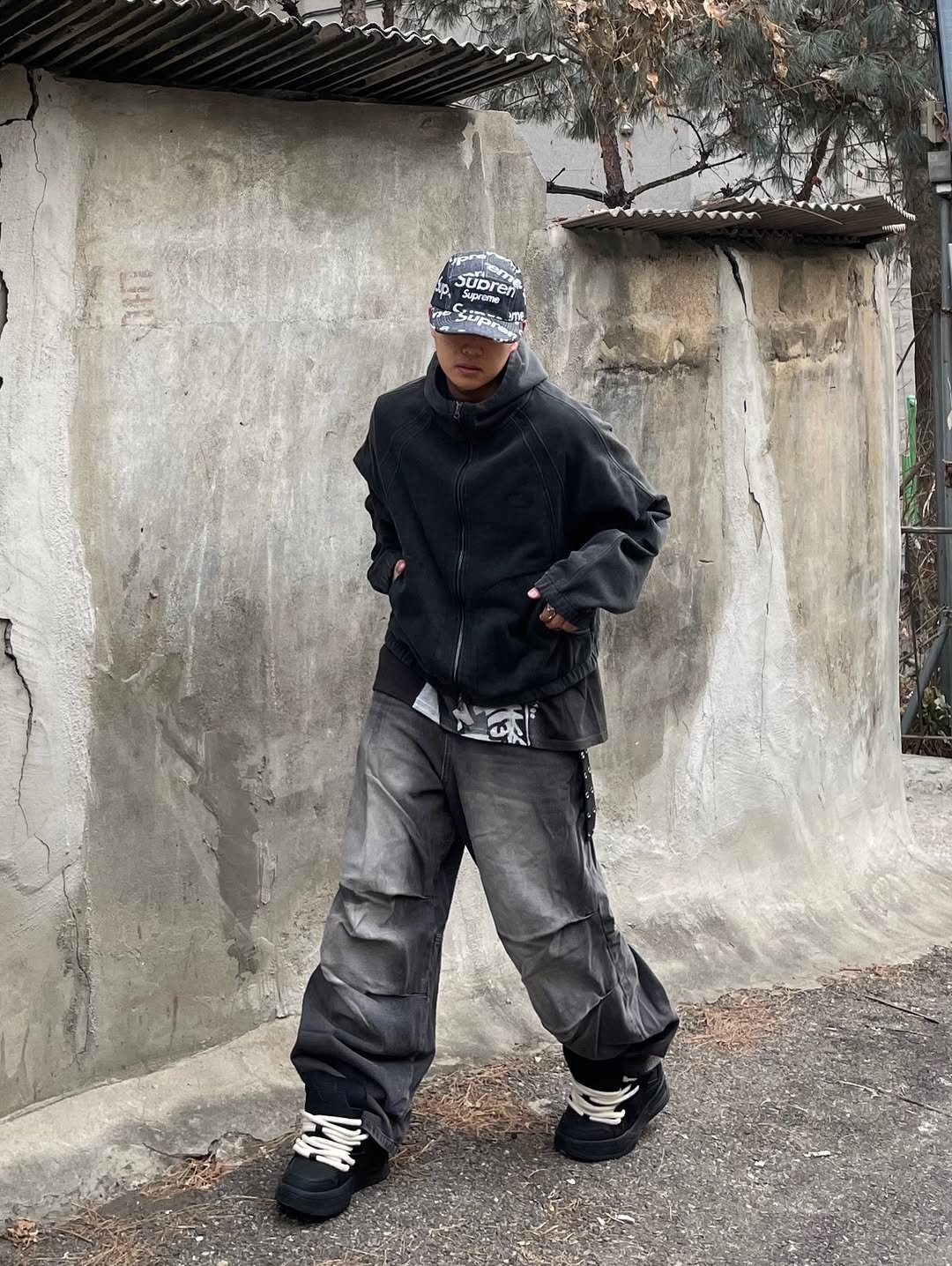 Photo shared by 정인 on February 01, 2026 tagging @dimitriblack_official. May be an image of duffle coat, goosedown coat, parka, raincoat, sweatpants, jacket, face mask and text.