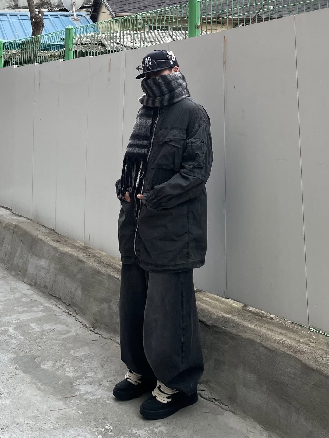 Photo shared by 정인 on December 16, 2025 tagging @areuban_official. May be an image of duffle coat, overcoat, face mask, parka, bandanna and text.