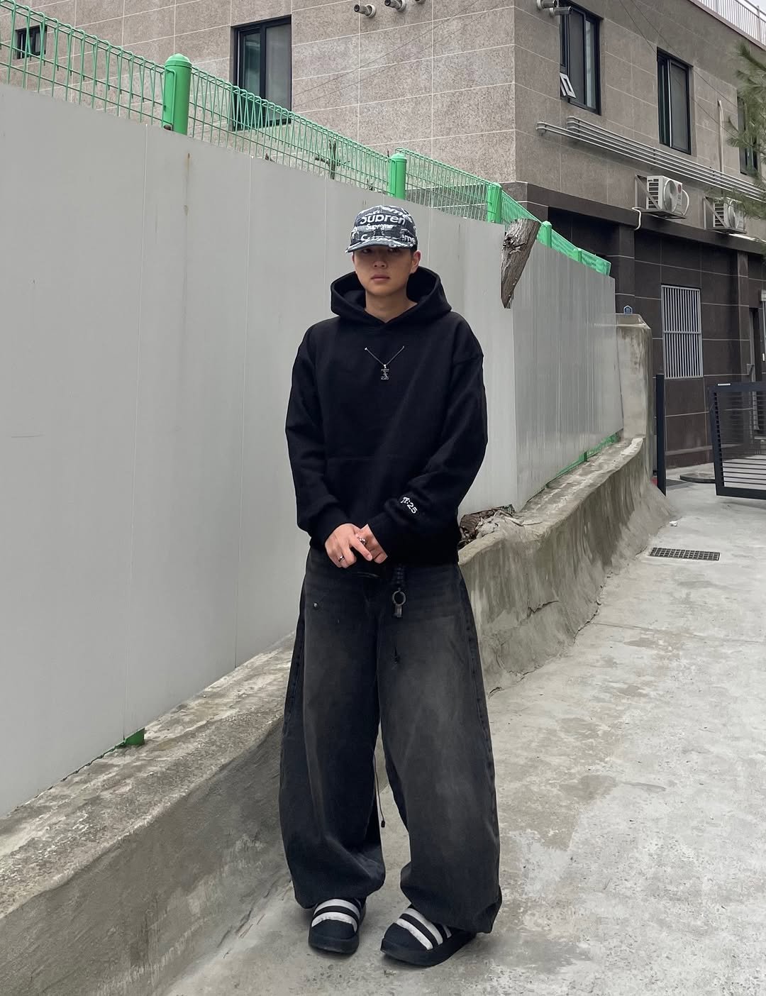 Photo shared by 정인 on January 28, 2026 tagging @hiver__official, and @threadx_official_. May be an image of standing, hat, parka, sweatsuit, sweatpants, street and text.