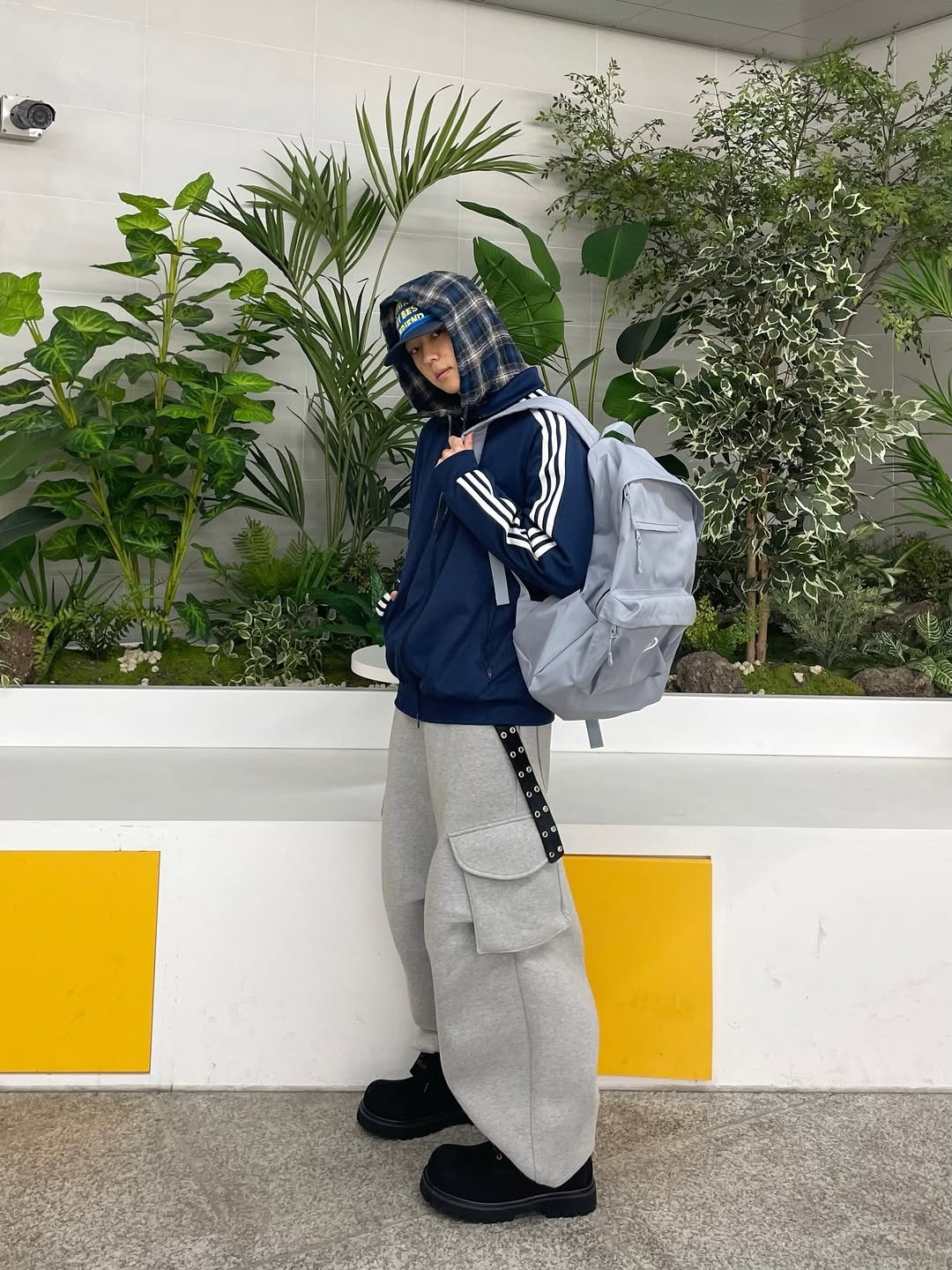 Photo shared by 정인 on February 18, 2026 tagging @originals_kr. May be an image of duffle coat, parka, sweatsuit, sweatpants, face mask and text.