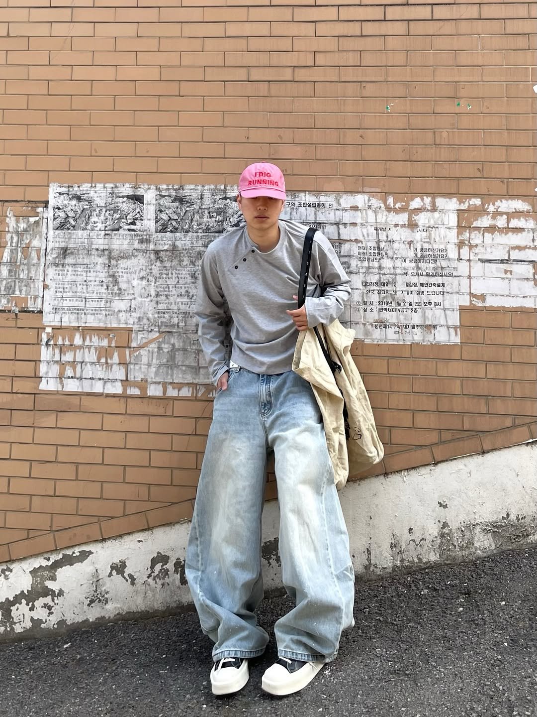 Photo shared by 정인 on April 24, 2026 tagging @xerobnr. May be an image of one or more people, hat, brick wall, curb and text.