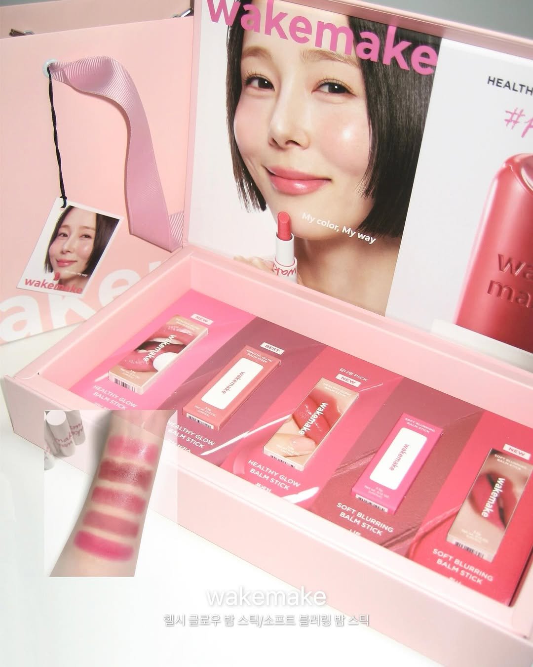 Photo shared by 미사 on February 11, 2026 tagging @wakemake_official. May be an image of one or more people, makeup, lipstick, cosmetics, hand cream and text.