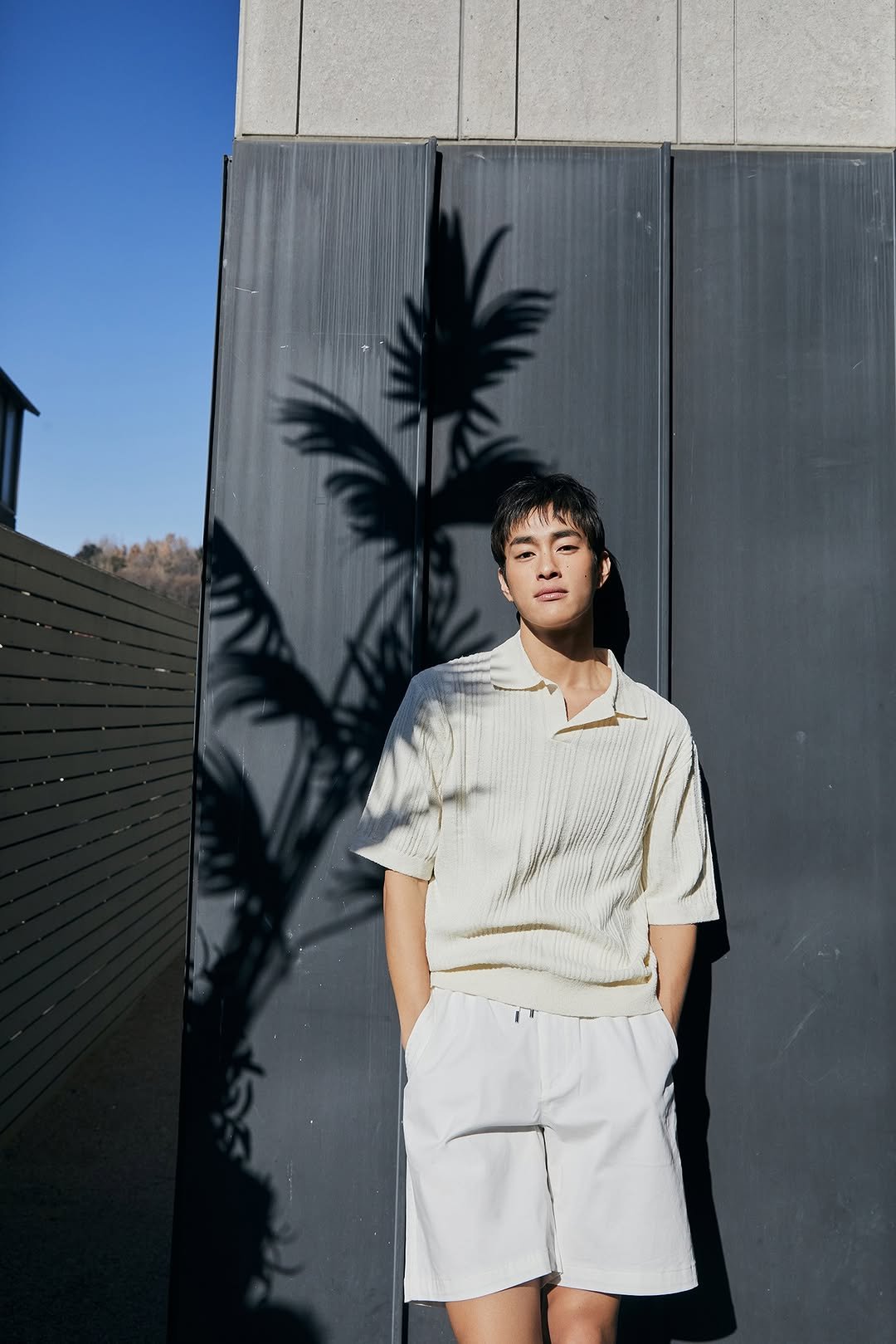 Photo by 컨셉원 concepts1one on August 17, 2025. May be an image of 1 person, top, shorts and text.