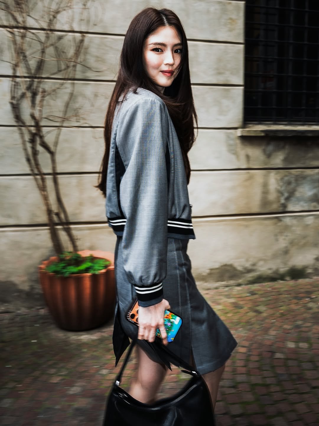 Photo shared by 창영 | changyoung on March 01, 2026 tagging @xeesoxee, and @fila_global. May be an image of duffle coat, purse, miniskirt and text.