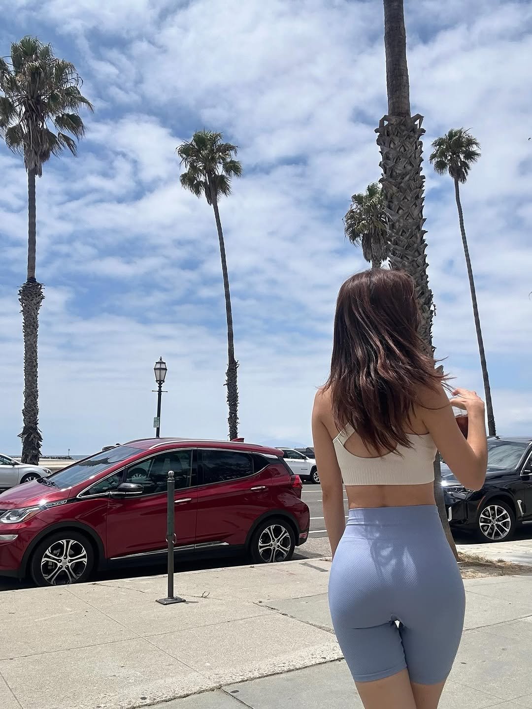 Photo shared by 𝘥𝘰𝘺𝘦𝘰𝘯 ෆ on July 30, 2025 tagging @thejoy_official. May be an image of 1 person, activewear, shorts, palm trees and text.