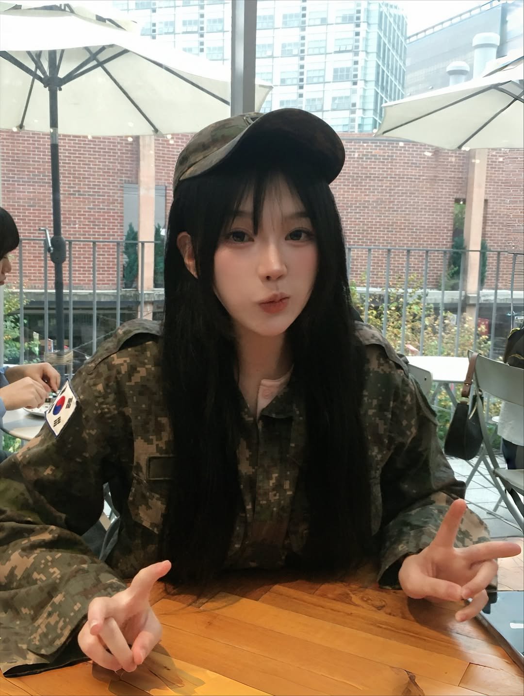Photo shared by 정윤경 on October 27, 2025 tagging @da9an9_vlo9. May be an image of one or more people, hair, military uniform, beret, parka and text.