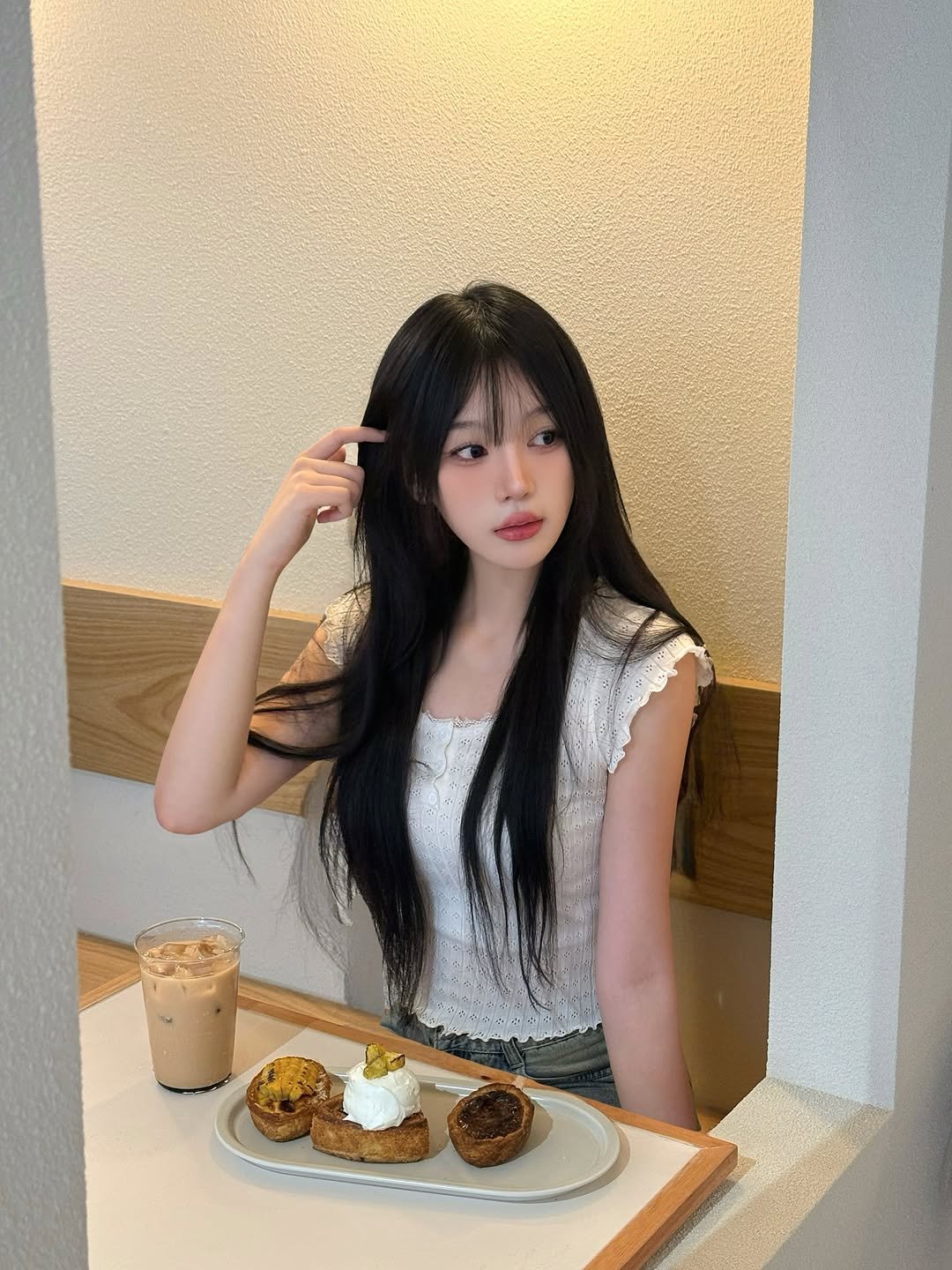 Photo shared by 정윤경 on October 01, 2025 tagging @da9an9. May be an image of 1 person, hair, dessert, top and text.