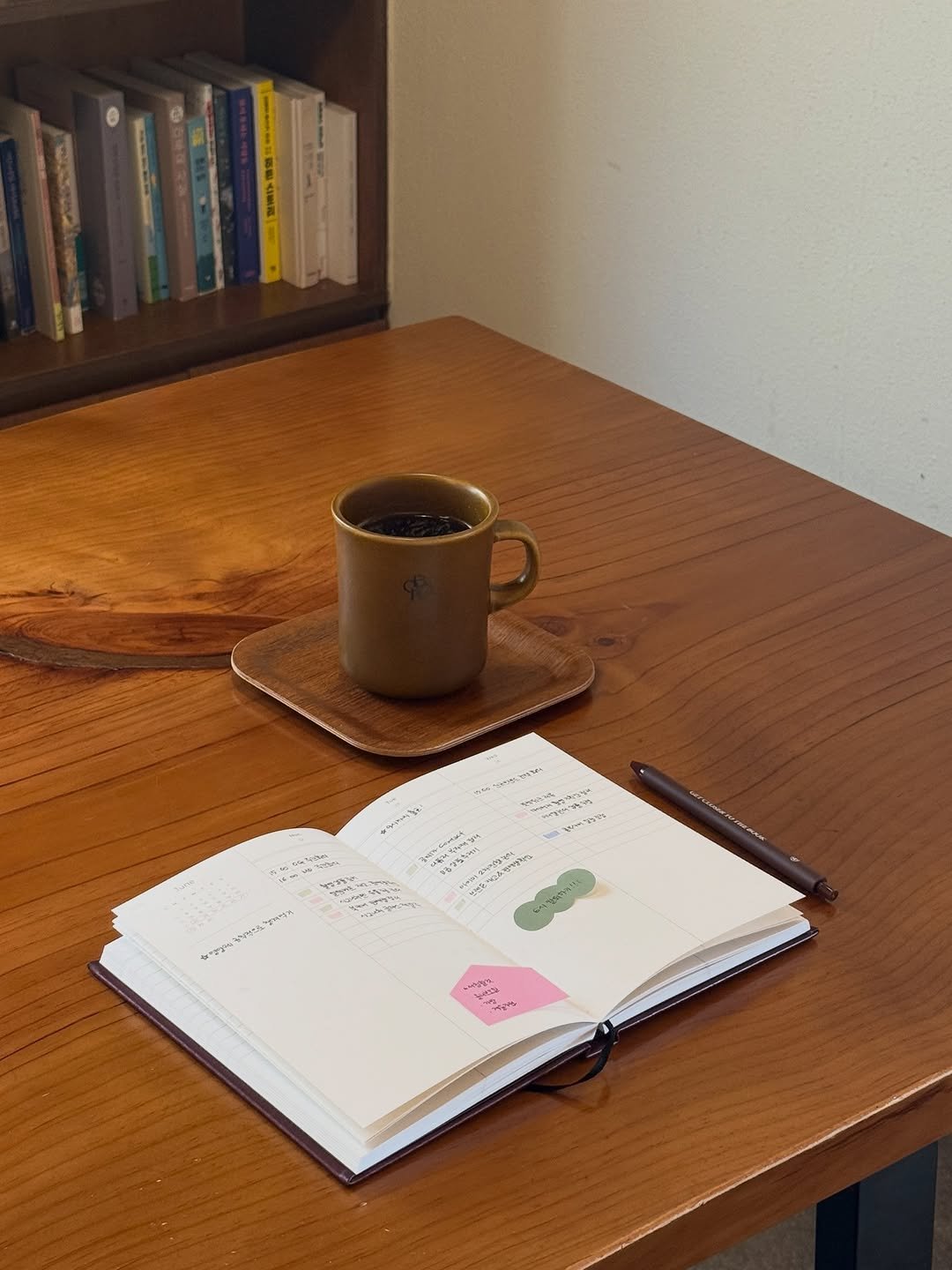 Photo by 당인리책발전소 on November 15, 2025. May be an image of diary, book, coffee cup, desk, clipboard, bureau and text.