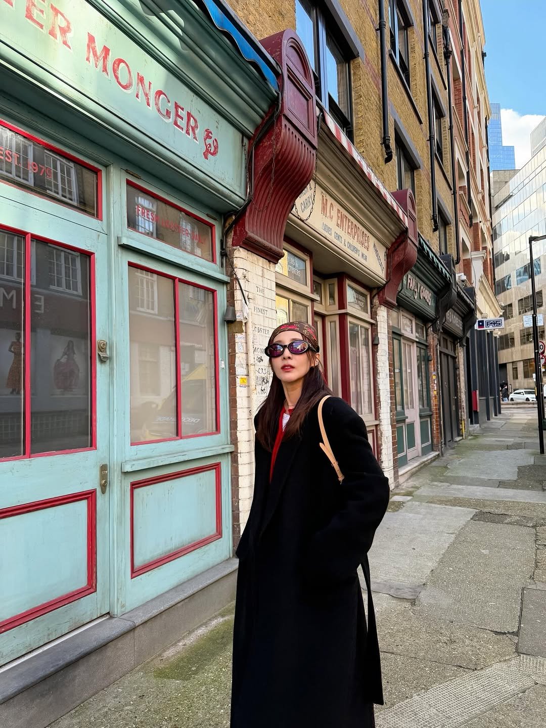 Photo by Sandara Park on March 12, 2026. May be an image of overcoat, duffle coat, eyewear, beret and text.