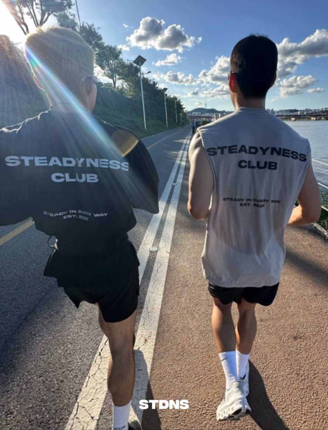 Photo shared by @steadyness.co.kr on September 21, 2025 tagging @day_steadyness. May be an image of 2 people, sportswear, shorts, road and text that says 'STEADYNESS CLUB STDNS'.