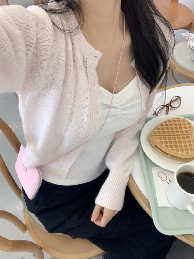 Photo by 오브던🌹 on February 24, 2026. May be an image of top, cardigan and text.