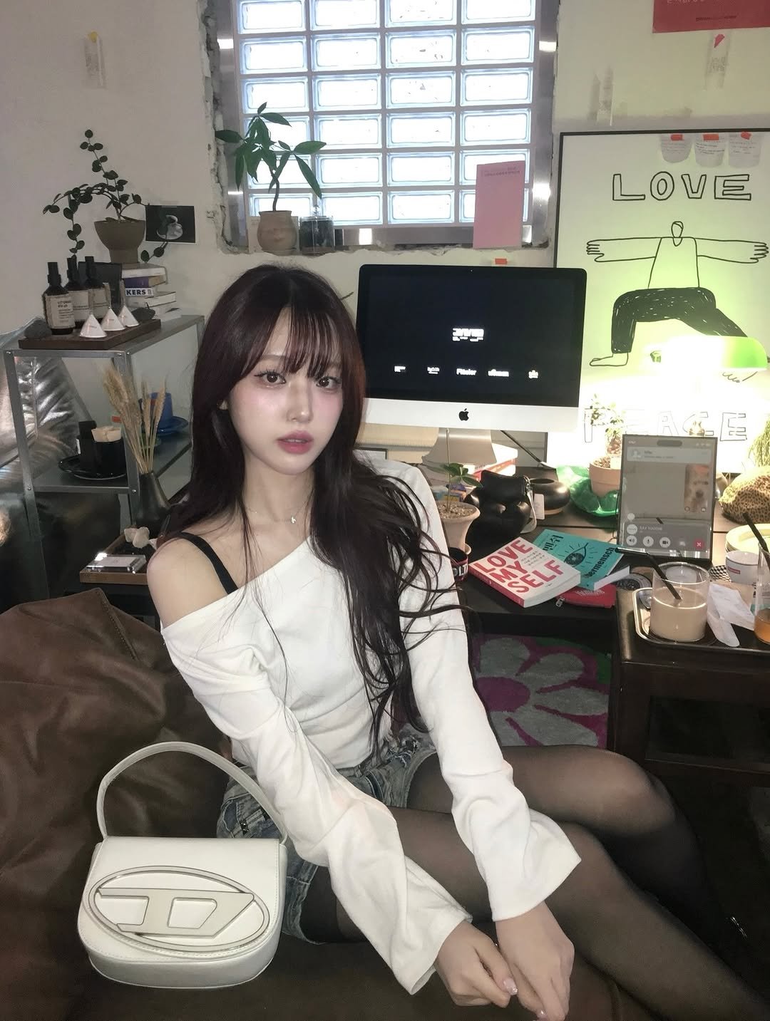 Photo by Hee on June 26, 2025. May be an image of 1 person, hair, top, miniskirt, purse and text.