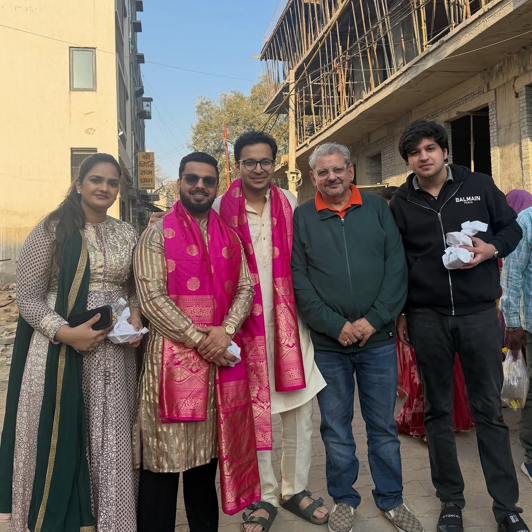 Photo shared by Anant Ladha on February 16, 2026 tagging @pushkarrajthakur, @shubhirajthakur, and @deepakwadhwa.official. May be an image of one or more people, people standing, shawl, temple and text.