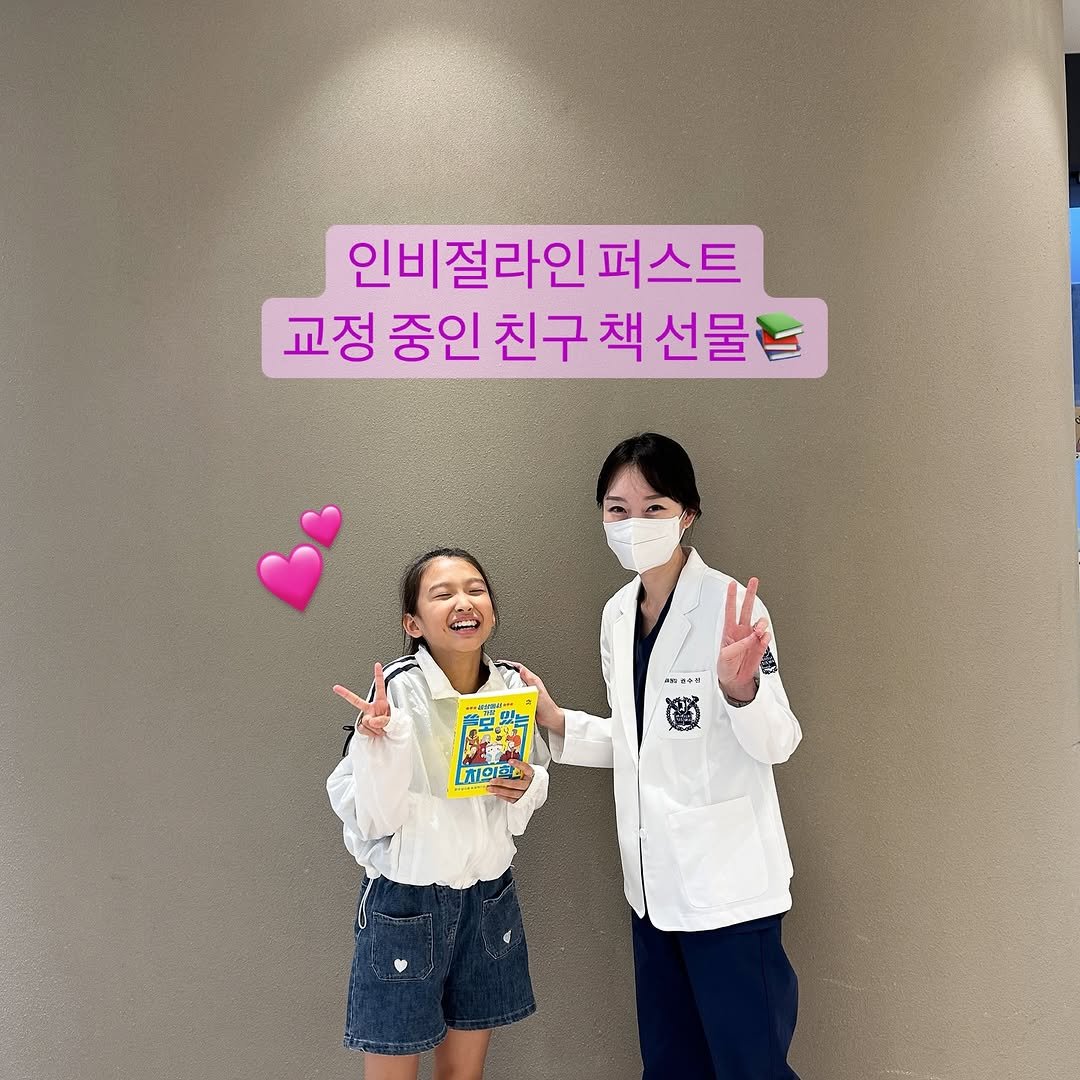 Photo shared by 권수진 | 치과의사 | 치아교정, 인비절라인 | 연년생 엄마 on September 09, 2025 tagging @pulbitkids, and @dentist_sujin. May be an image of 2 people, stethoscope, hospital and text that says '인비절라인퍼스트 인비절라인 퍼스트 교정 중인 친구 책 교정중인친구책선물 선물 魔對 치의학'.