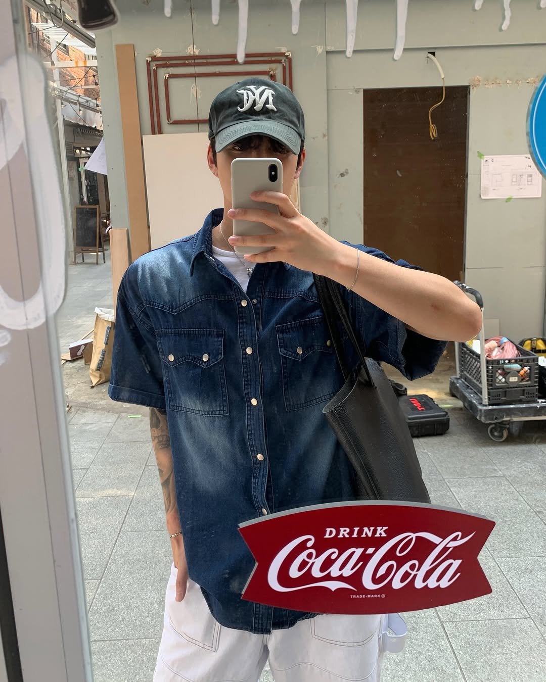 Photo by 도형, 디멘트 DMENT on July 30, 2025. May be an image of 1 person and text that says 'DV C BLA Coca-Cola DRINK TRAGE'.
