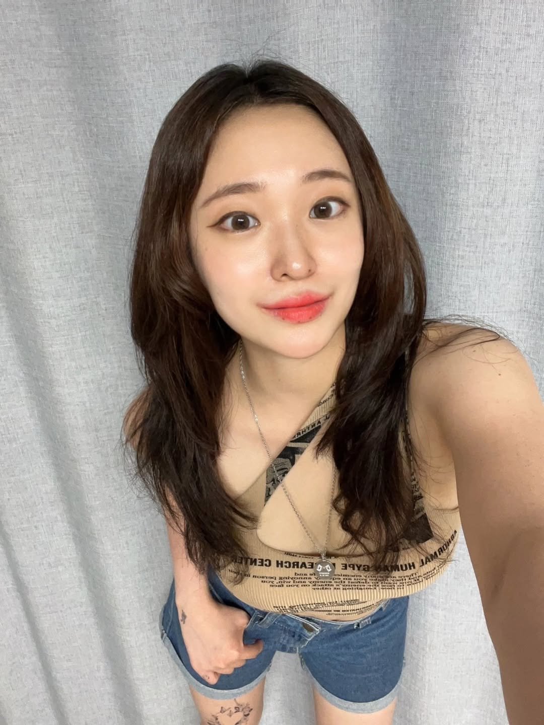 Photo shared by DJ Uni 최유정 on August 12, 2025 tagging @ololalens_kr. May be a selfie of 1 person, hair, top, shorts and text.