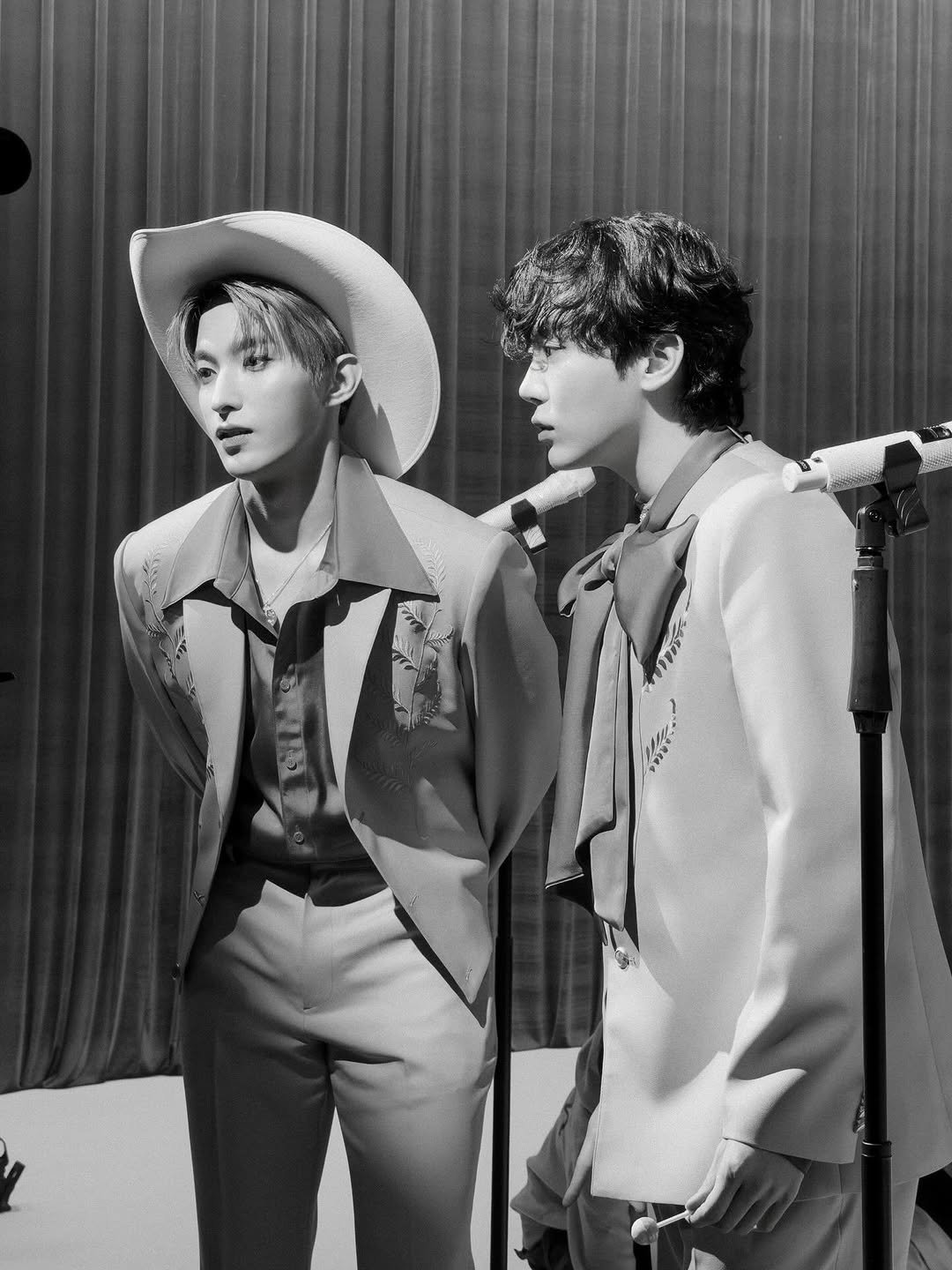 Photo shared by 도겸 on December 20, 2025 tagging @pledis_boos. May be a black-and-white image of one or more people, bangs, bolo tie and text.