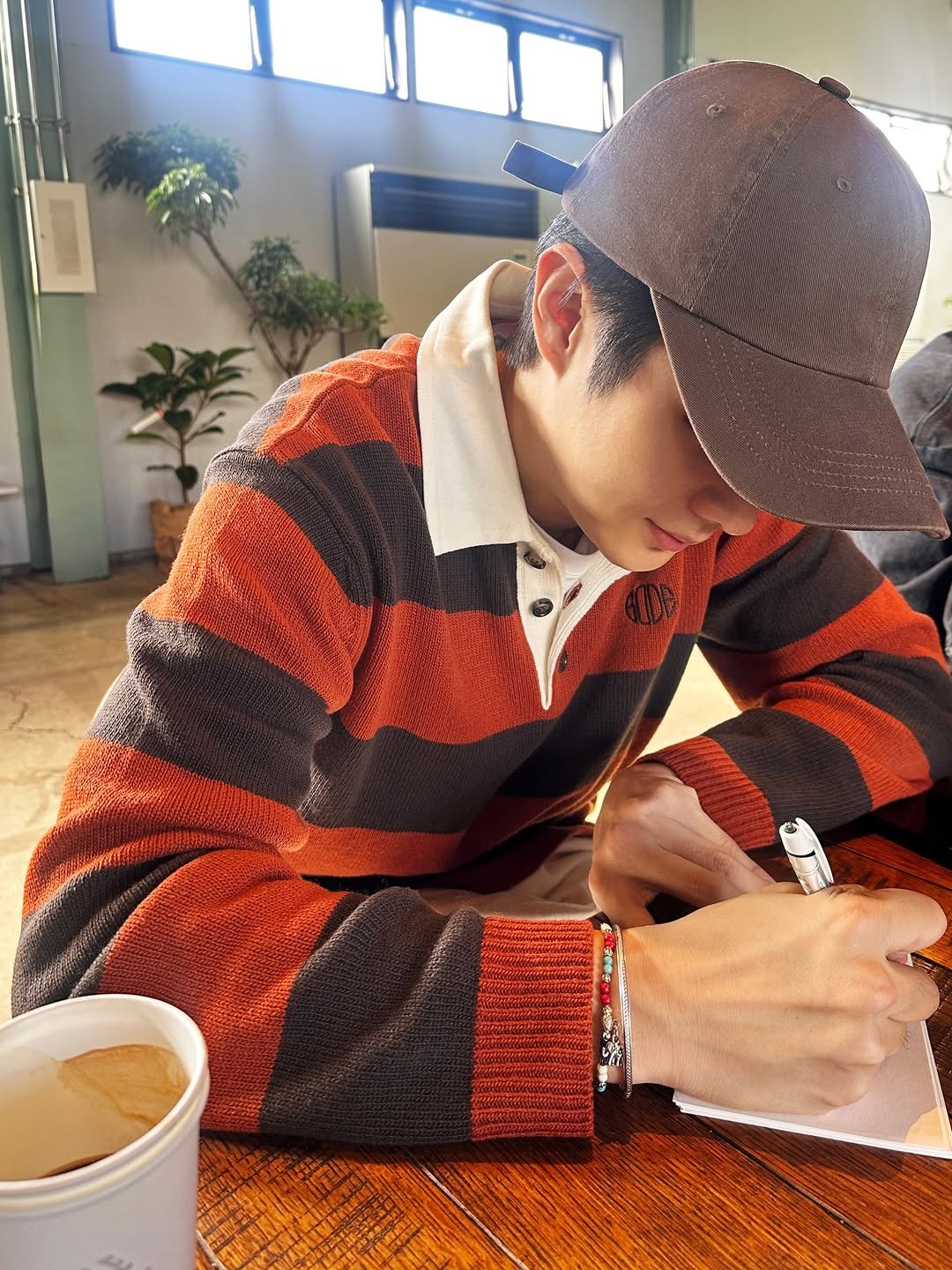 Photo by CHOIWOOSHIK on February 05, 2026. May be an image of studying, hat, sweater and text.