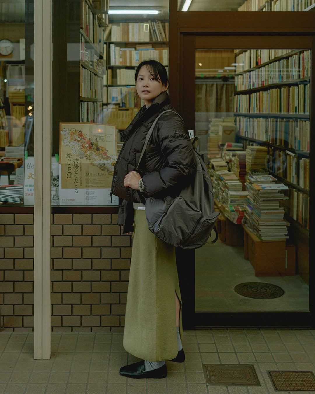 Photo shared by 윤승아 on November 27, 2025 tagging @fila_korea. May be an image of one or more people, duffle coat, street and text.