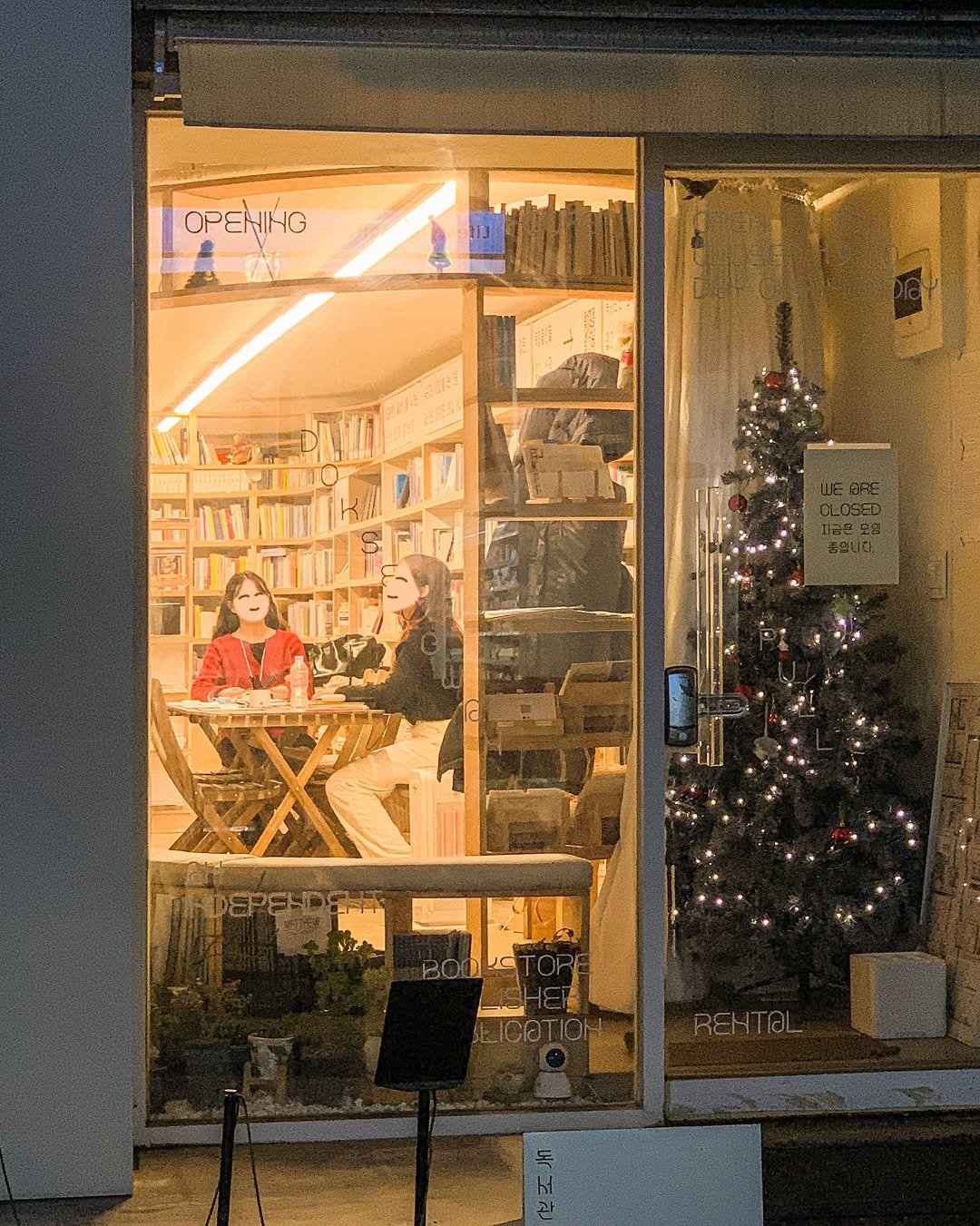 Photo shared by 독서관 on February 13, 2026 tagging @book_and_sky. May be an image of display case, newsstand, street, window and text.