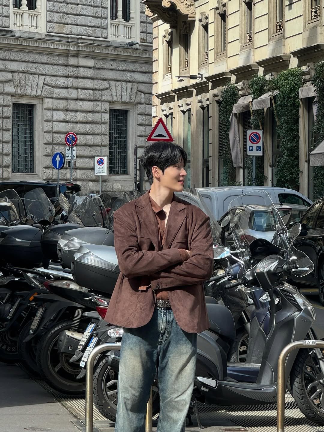 Photo by 국 동호 on October 30, 2025. May be an image of suit, overcoat, cigarette, beret, scooter, street and text.
