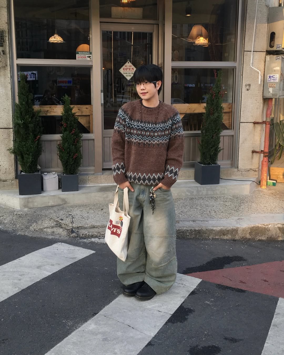 Photo shared by 투븐 / TOVN on December 10, 2025 tagging @tovn_official. May be an image of duffle coat, turtleneck, parka and text.