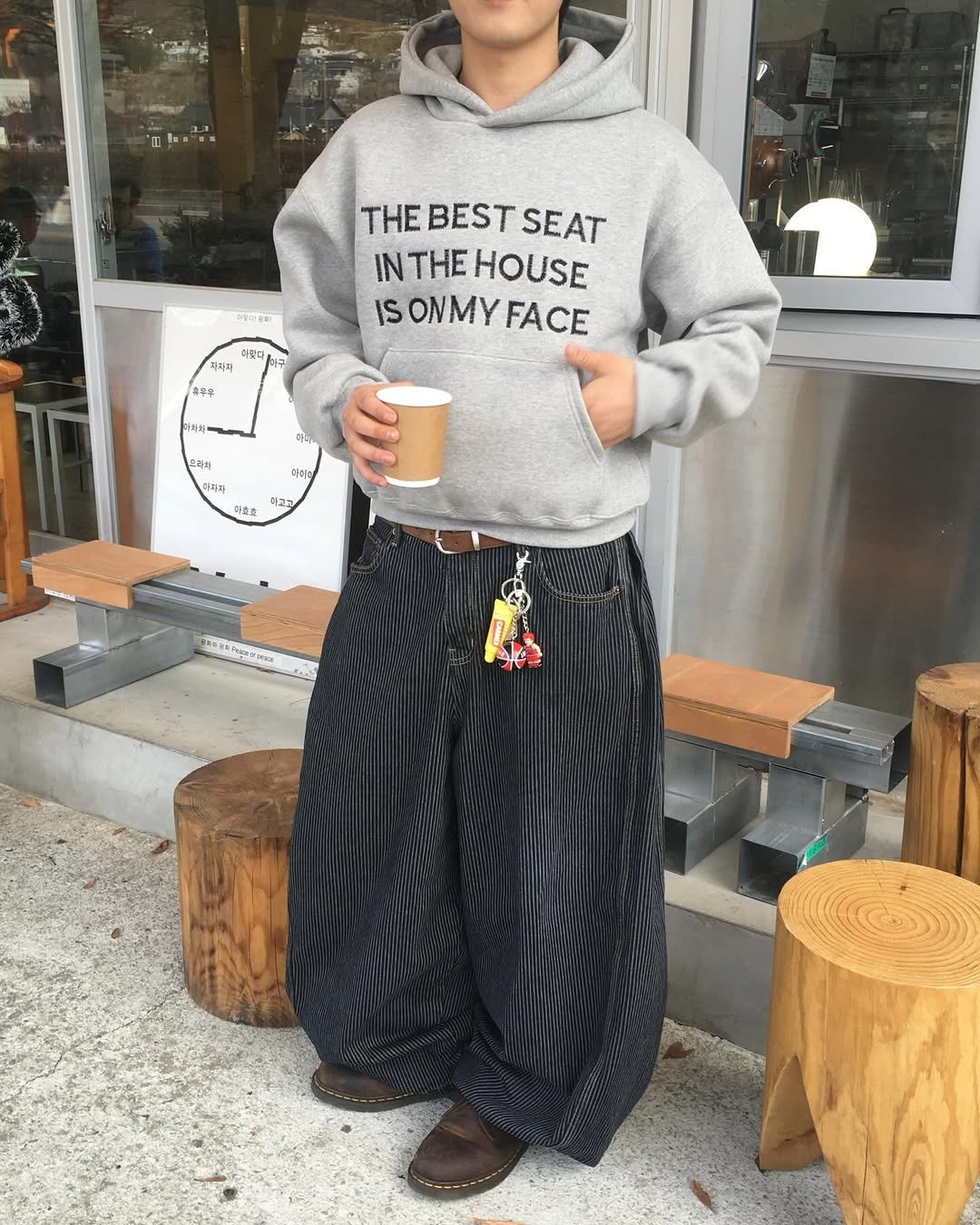 Photo shared by 투븐 / TOVN on December 21, 2025 tagging @drmartensofficial, and @tovn_official. May be an image of sweatshirt, sweatpants, cornflower and text.