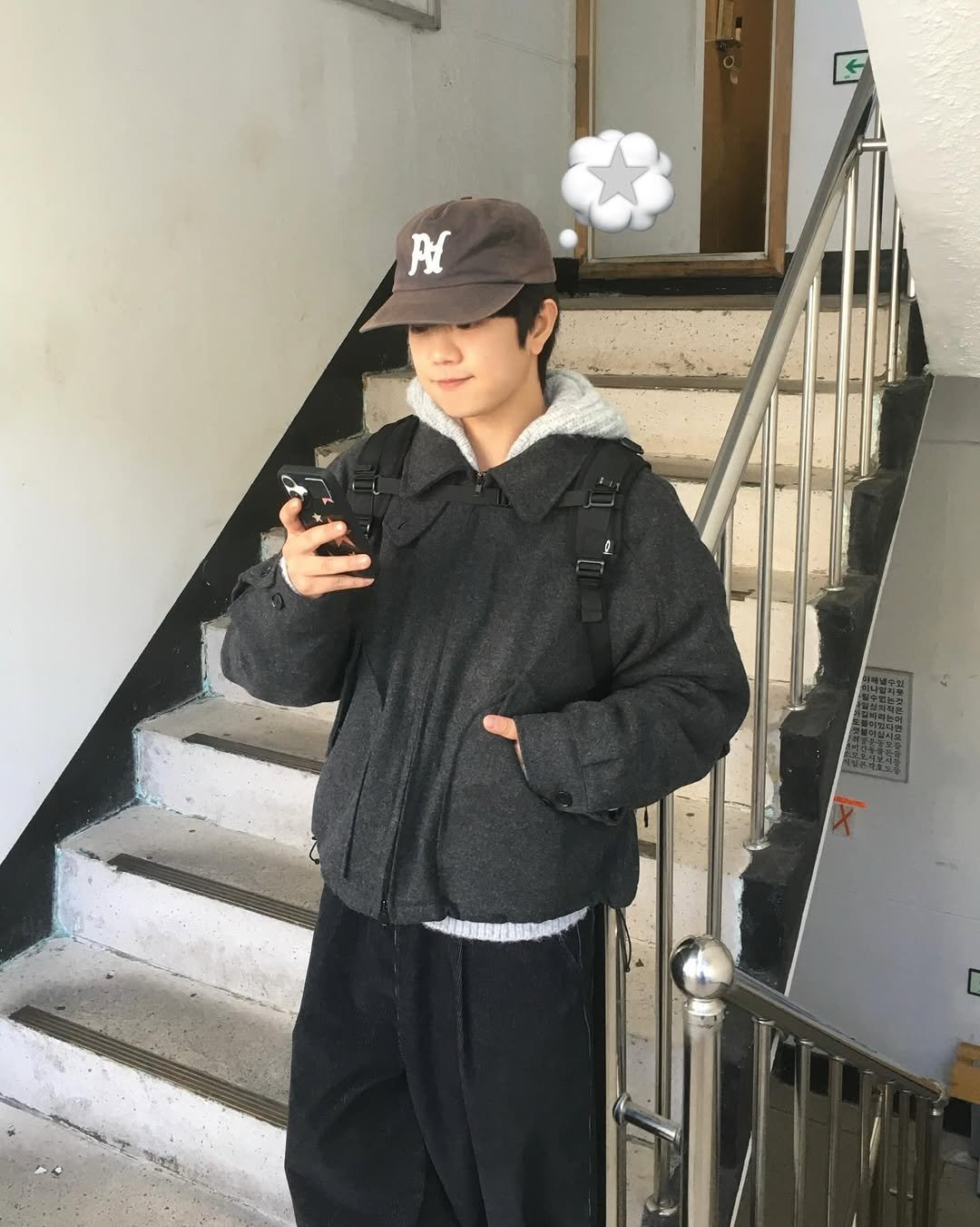 Photo shared by 투븐 / TOVN on December 26, 2025 tagging @tovn_official. May be an image of phone, duffle coat, sweatpants, parka, sweatsuit and text.