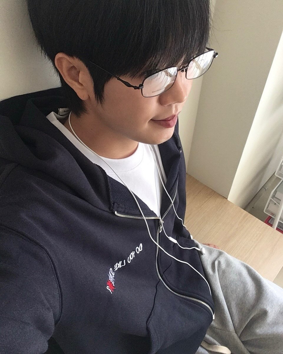 Photo shared by 동현 / 투븐 TOVN on September 28, 2025 tagging @tovn_official. May be an image of 1 person, hair, duffle coat, eyeglasses, sweatshirt, parka, sweatpants and text.