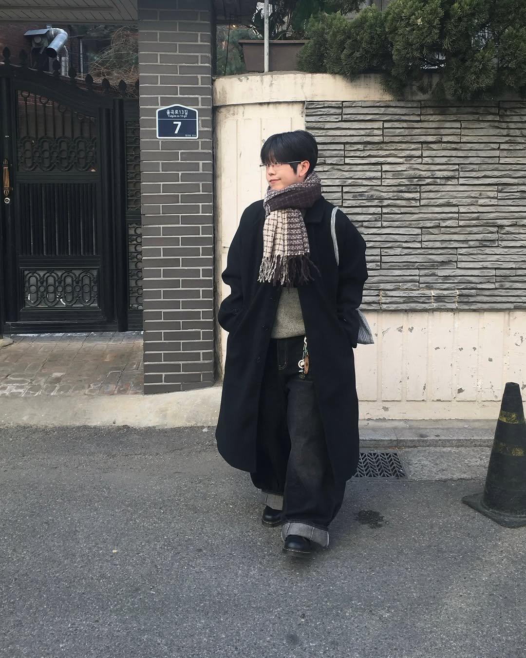 Photo shared by 투븐 / TOVN on December 09, 2025 tagging @tovn_official. May be an image of duffle coat, overcoat, parka, cloak, kilt, beret and text.