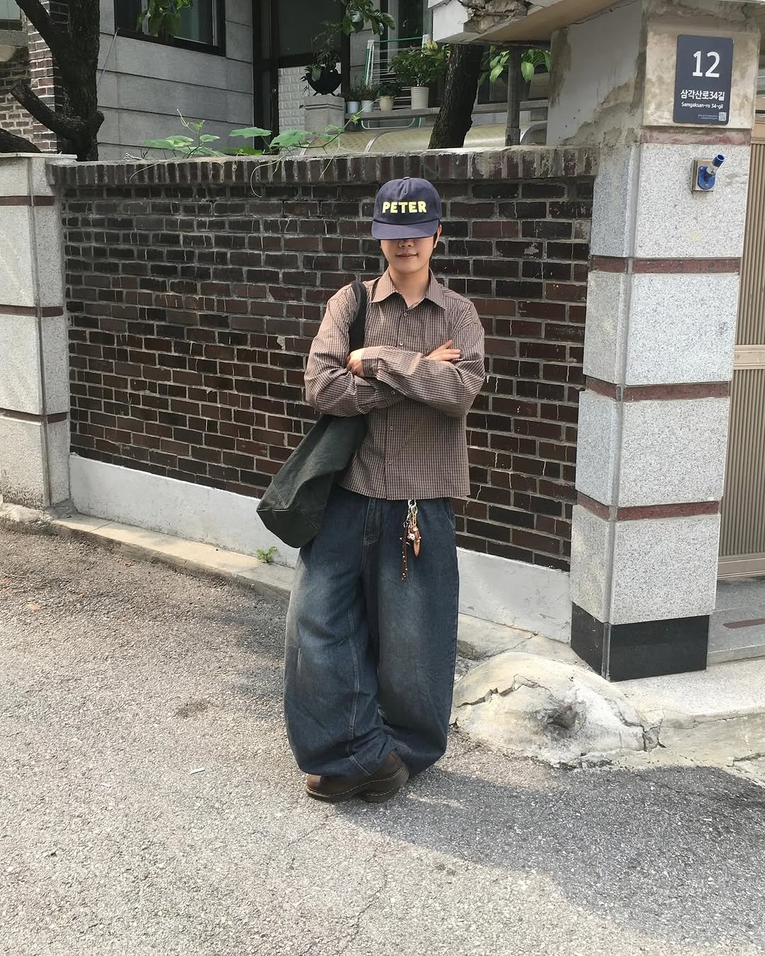Photo shared by 동현 / 투븐 TOVN on September 18, 2025 tagging @tovn_official. May be an image of ‎1 person, hat, duffle coat and ‎text that says '‎12 상각산로34길 سستام 圖 PETER‎'‎‎.