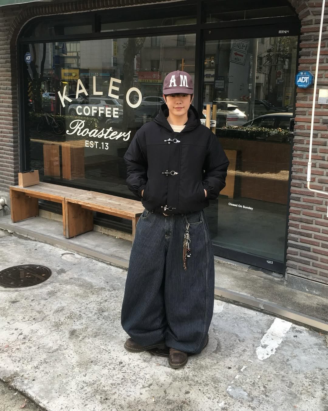 Photo shared by 투븐 / TOVN on December 18, 2025 tagging @drmartensofficial, @tovn_official, and @amou.co.kr. May be an image of ‎sarong and ‎text that says '‎V00 無限： AM ADT 아히 KALEO COFFEE Roasters EST.13 شي Closes Suedary 9‎'‎‎.