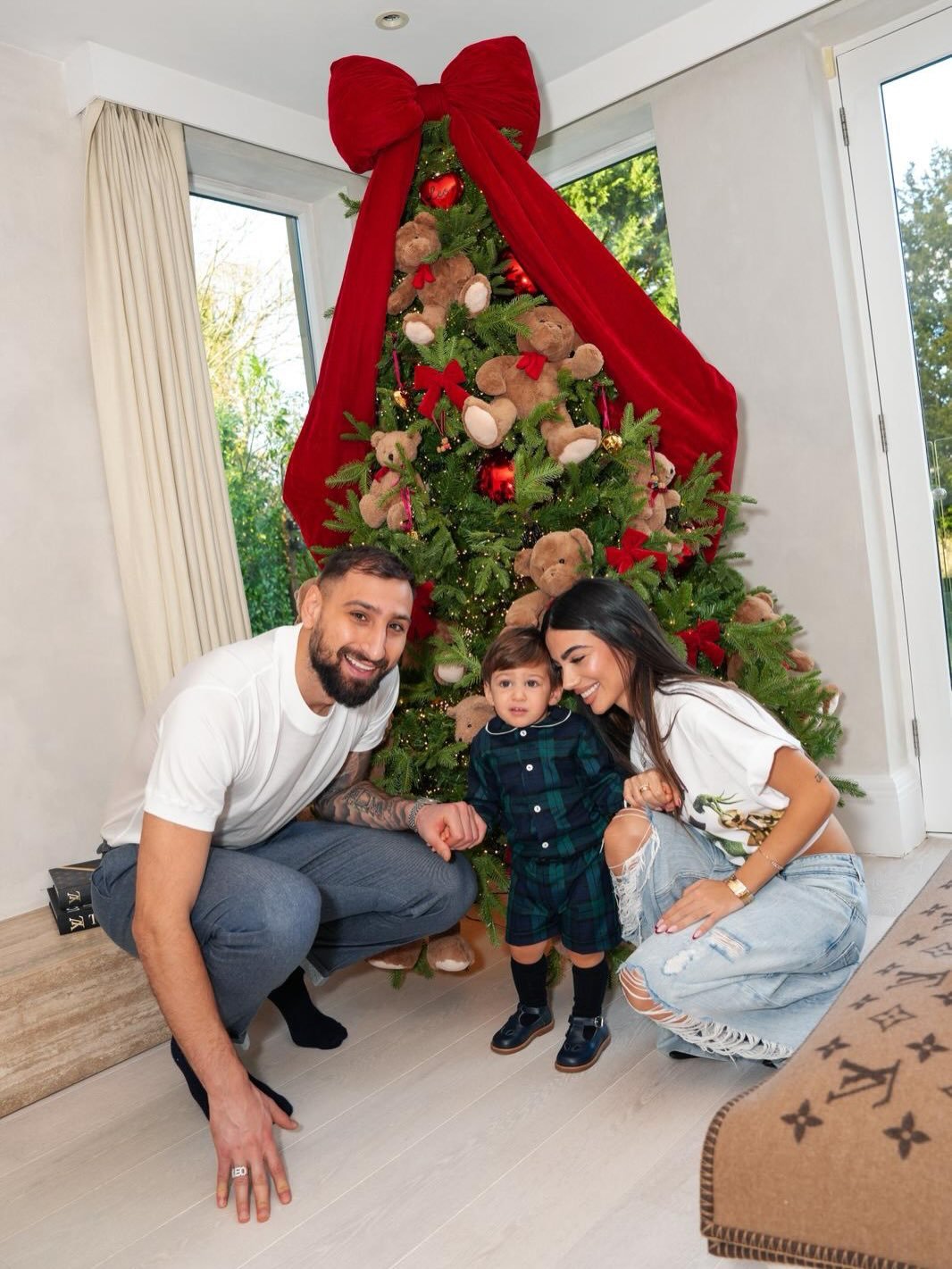 Photo shared by GIANLUIGI DONNARUMMA on December 24, 2025 tagging @alessiaelefante. May be an image of baby, christmas tree and text.